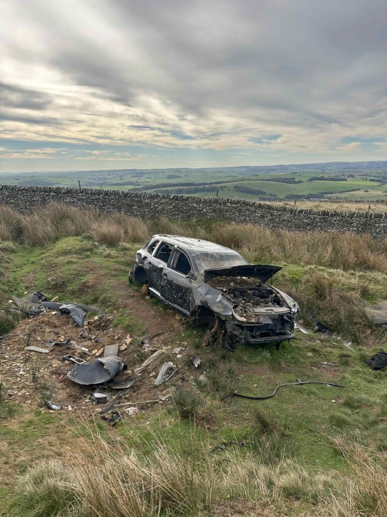 The wreck of a Porsche Cayenne 4x4 on Rushup Edge